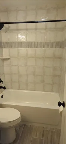 a bathroom with a bathtub and a toilet