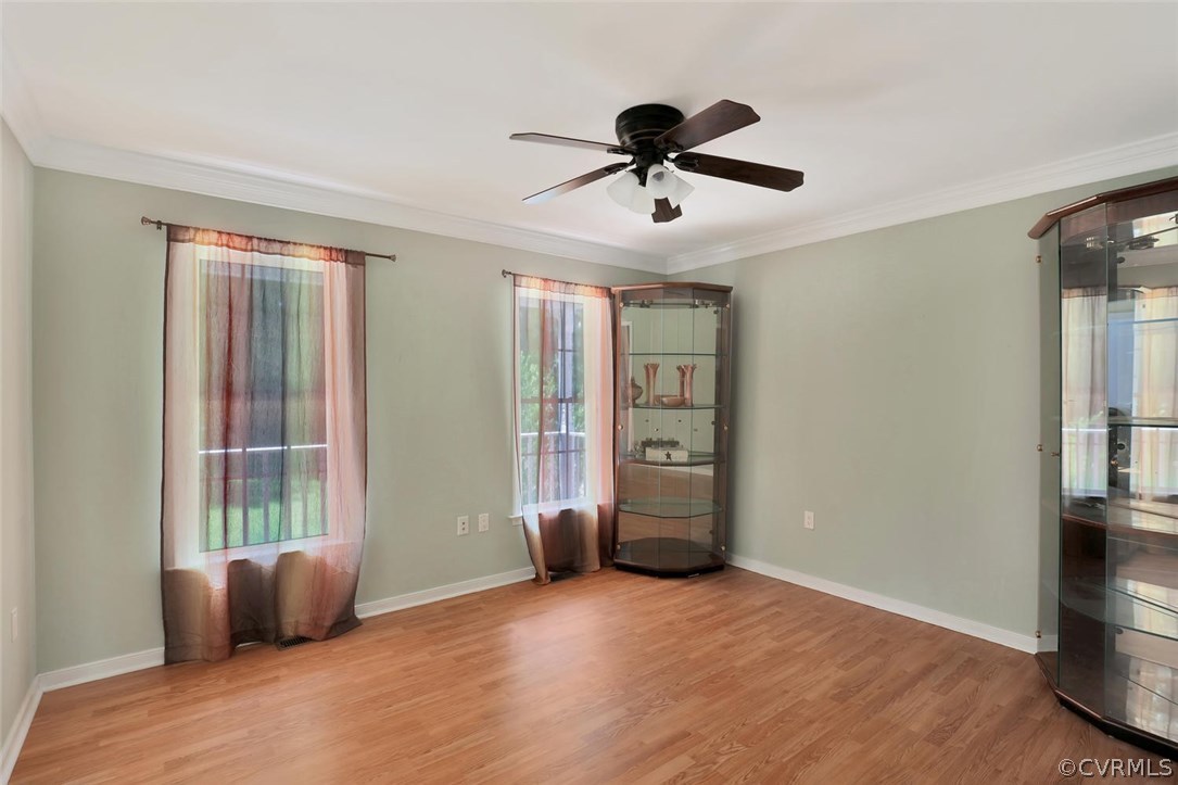 1554 Walkers Ridge Road Powhatan, VA 23139 - Photo 4 of 24 Dining room with laminate flooring and crown moldi