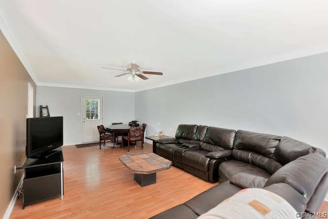1554 Walkers Ridge Road Powhatan, VA 23139 - Photo 5 of 24 Living room with laminate flooring, crown molding