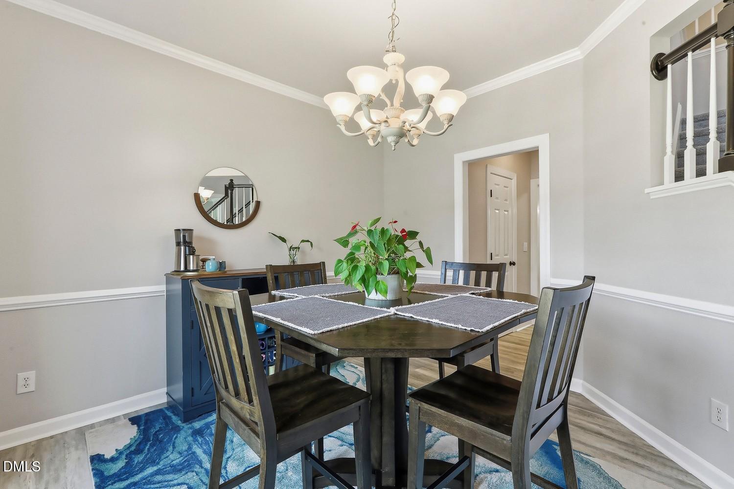4001 Batiste Road Raleigh, NC 27613 - Photo 24 of 63 a view of a dining room with furniture and chandelier