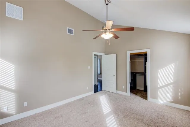 a view of a chandelier fan and a livingroom with a chandelier fan