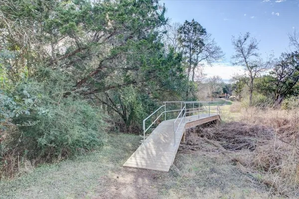 a view of a yard with large trees