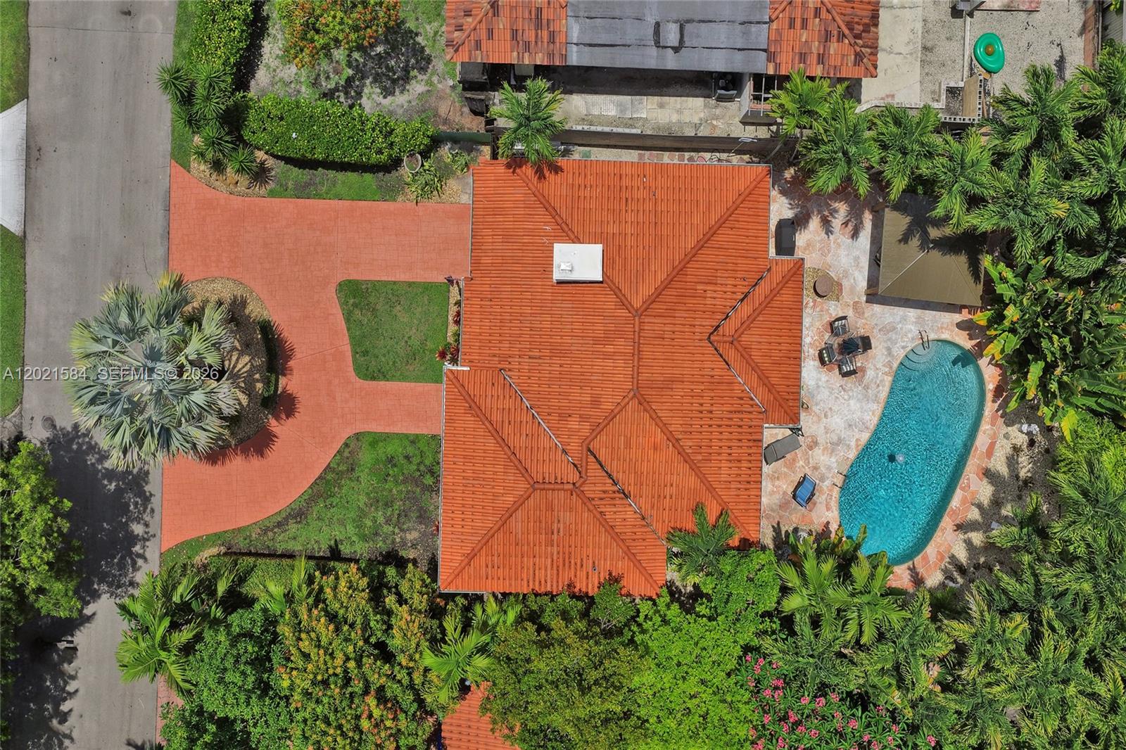 811 Northeast 73rd Street Miami, FL 33138 - Photo 4 of 51 an aerial view of a house with a yard and garden