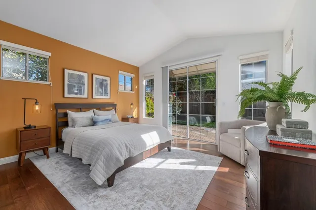 a spacious bedroom with a bed and a large window