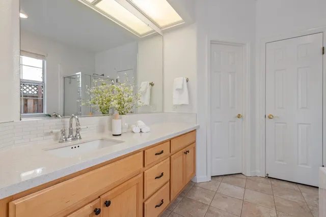 a spacious bathroom with 2 sink and a mirror