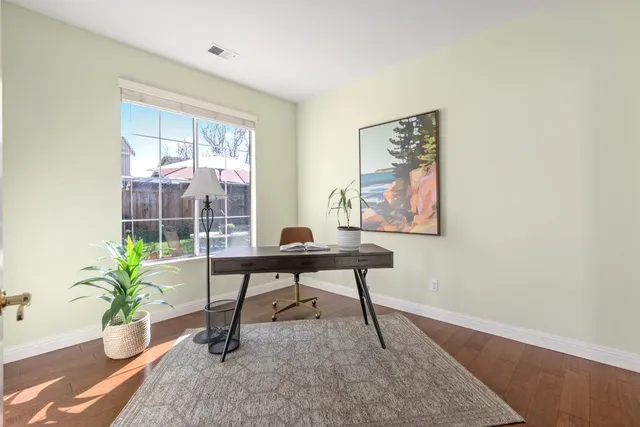 a work room with furniture and a potted plant