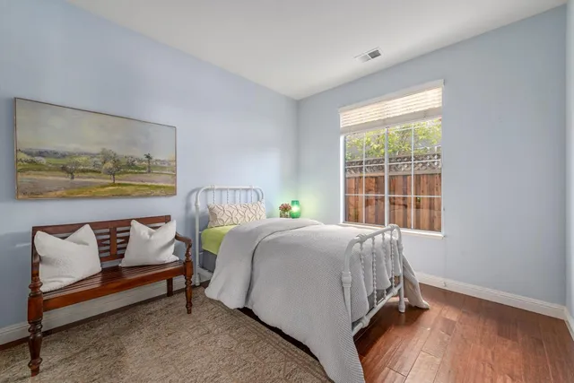 a bed sitting in a bedroom next to a window
