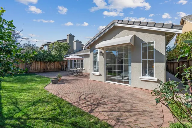 a front view of a house with yard and green space