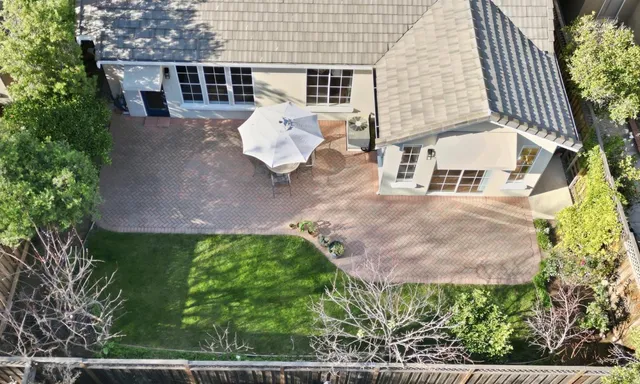 an aerial view of a house with a yard and lake view
