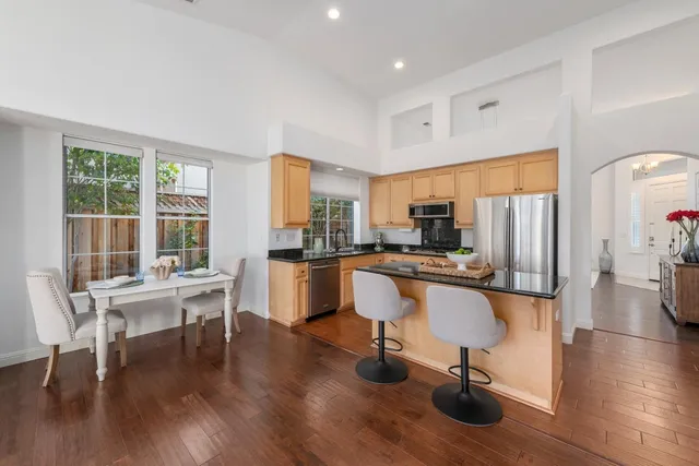a view of a kitchen with dining table and chairs