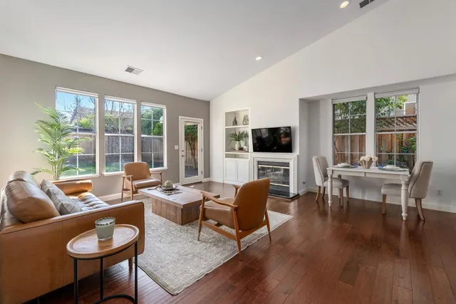 a living room with fireplace furniture and a flat screen tv