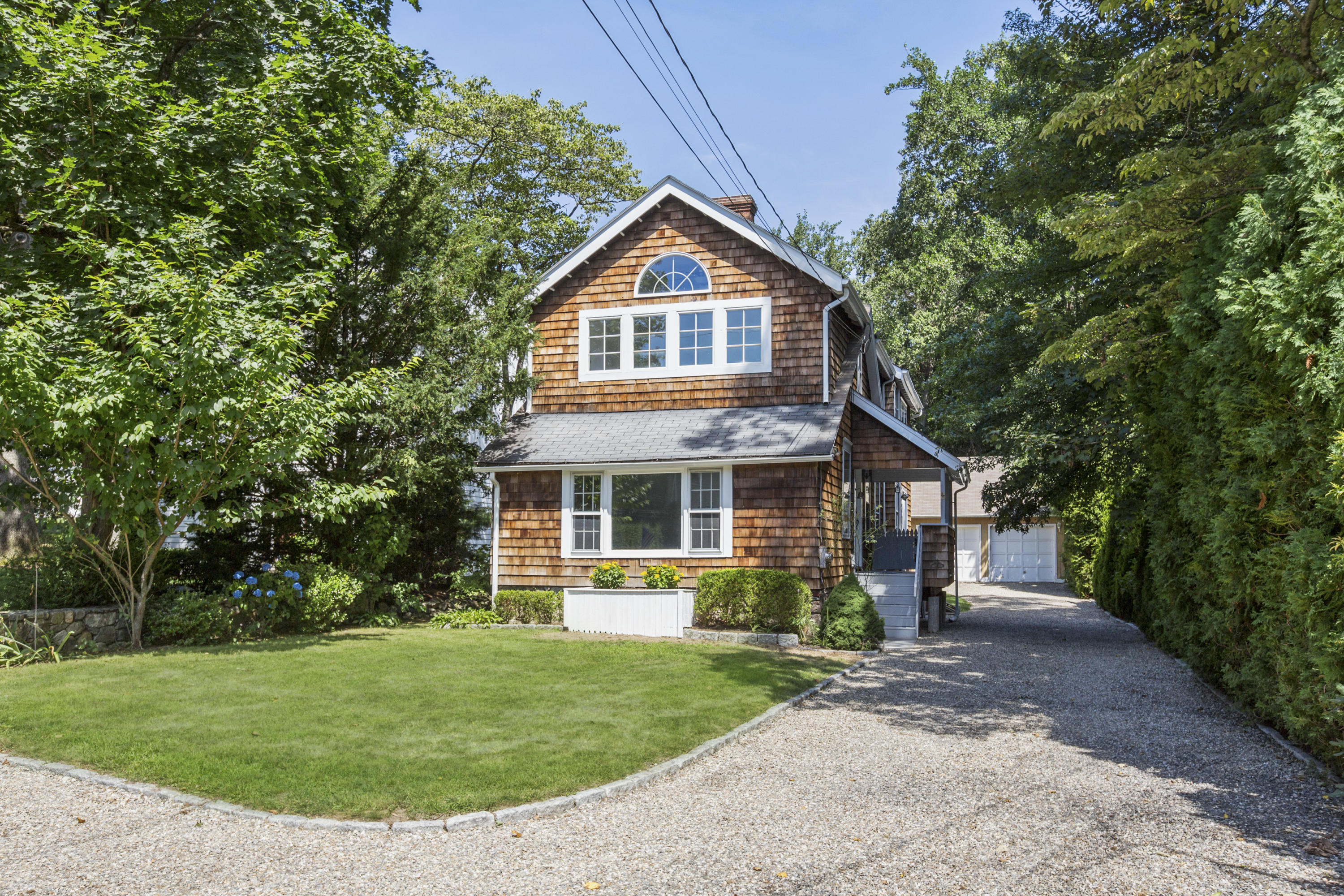 28 Edgewood Road Darien, CT 06820 - Photo 20 of 23 a front view of a house with garden