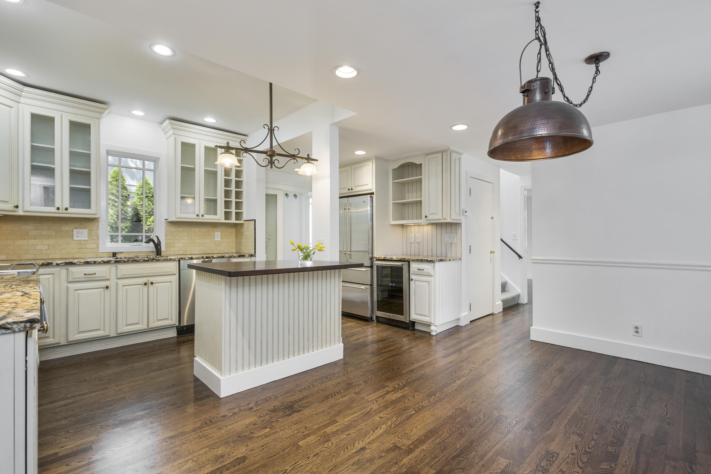 28 Edgewood Road Darien, CT 06820 - Photo 4 of 23 a kitchen with stainless steel appliances granite countertop a refrigerator a sink dishwasher a stove and white cabinets with wooden floor