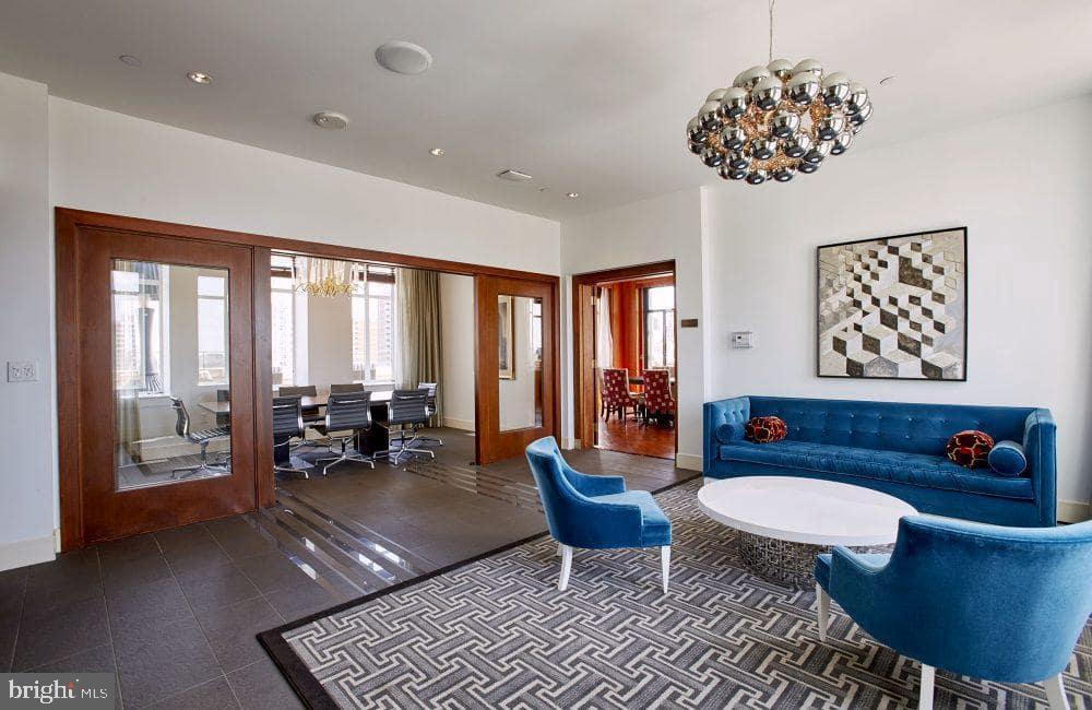 a living room with furniture a rug and a chandelier