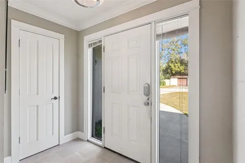 a living room with furniture a table and kitchen view