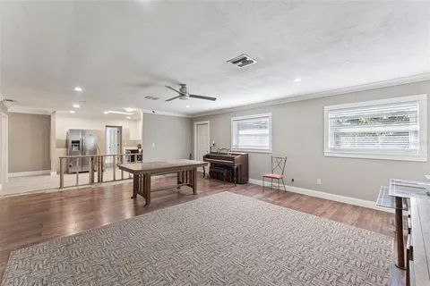 a living room with furniture a fireplace and a piano