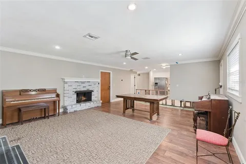 a living room with furniture a table and wooden floor