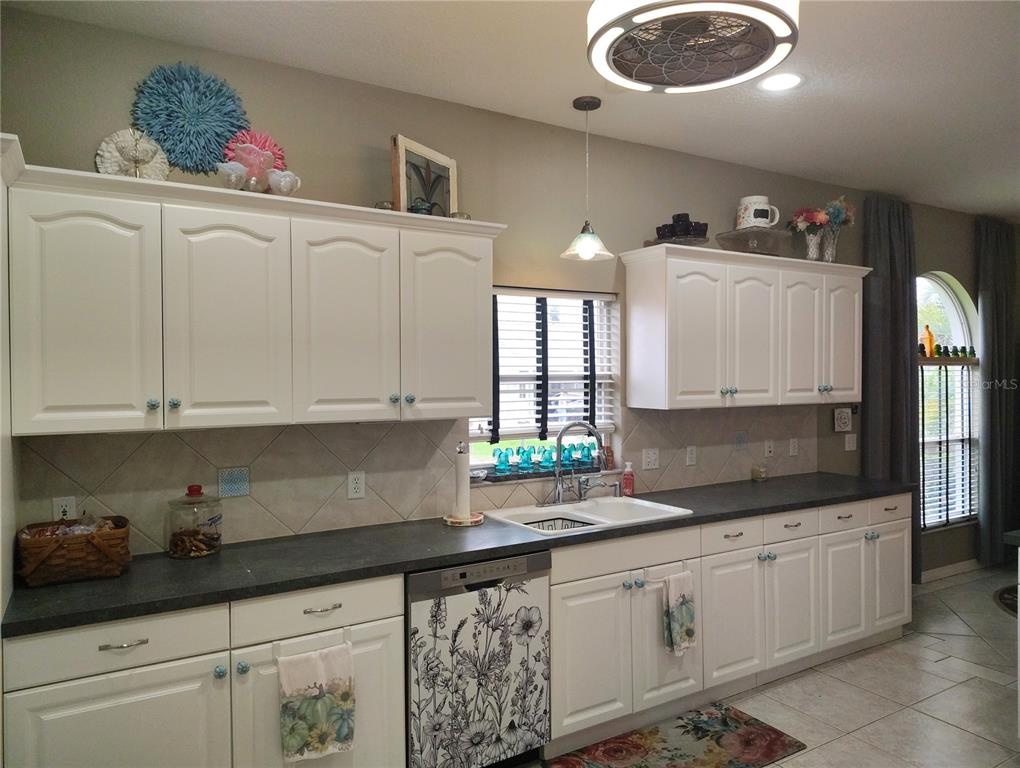 3315 Elm Street Ellenton, FL 34222 - Photo 11 of 51 a kitchen with granite countertop white cabinets and sink