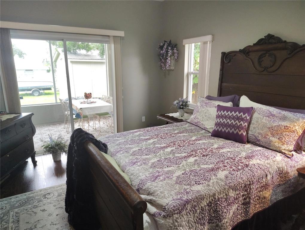 3315 Elm Street Ellenton, FL 34222 - Photo 13 of 51 a bedroom with a large bed and wooden floor