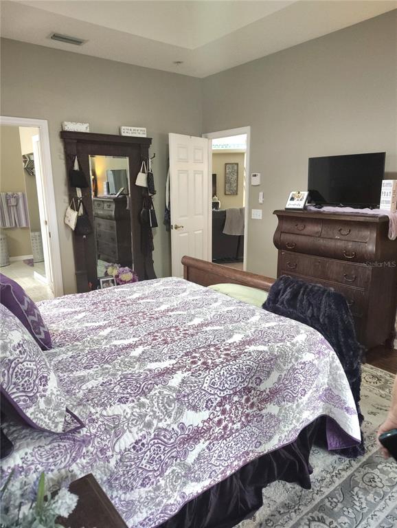 3315 Elm Street Ellenton, FL 34222 - Photo 14 of 51 a bedroom with a bed and a flat screen tv