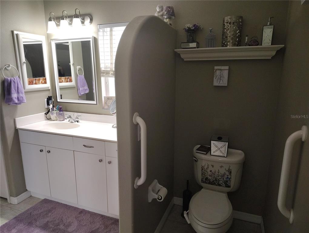3315 Elm Street Ellenton, FL 34222 - Photo 19 of 51 a bathroom with a toilet sink and mirror