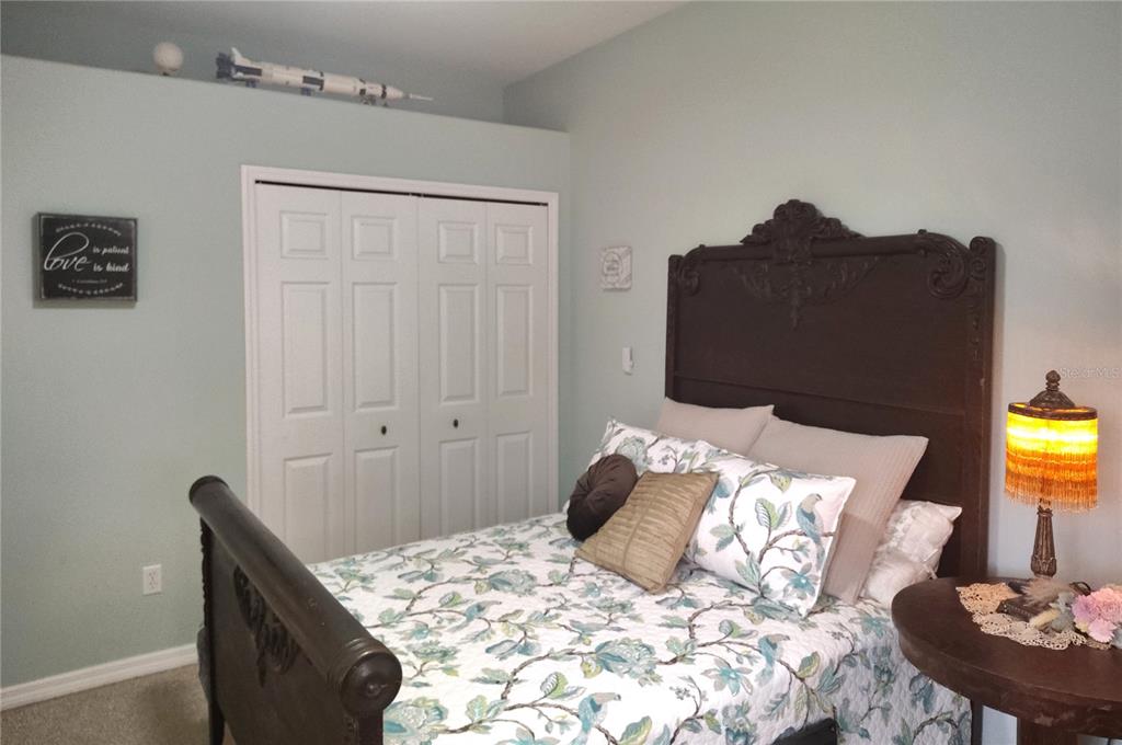 3315 Elm Street Ellenton, FL 34222 - Photo 26 of 51 a bedroom with a bed and a lamp on dresser