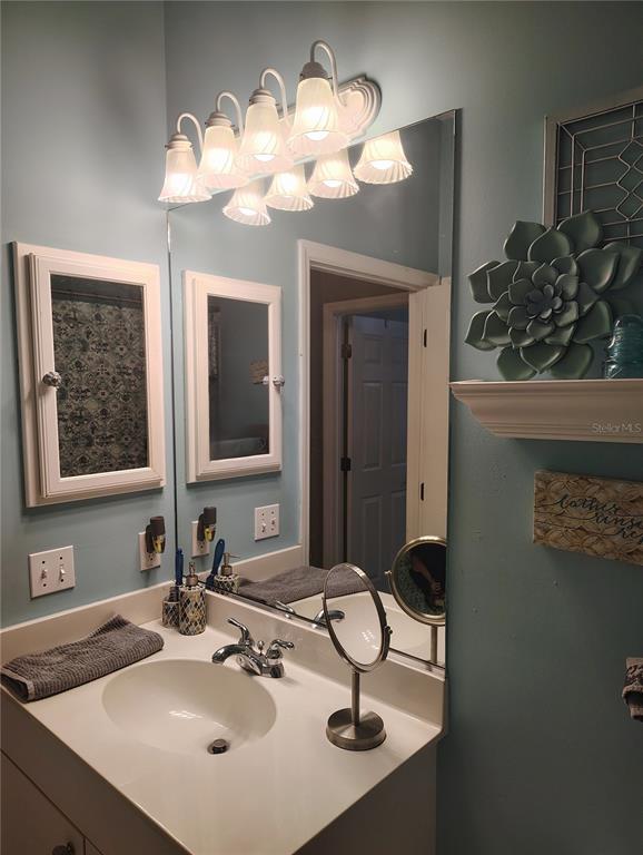 3315 Elm Street Ellenton, FL 34222 - Photo 30 of 51 a bathroom with a sink and a mirror