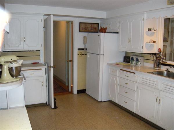 117 Radcliffe Road Belmont, MA 02478 - Photo 4 of 6 a kitchen with white cabinets and refrigerator