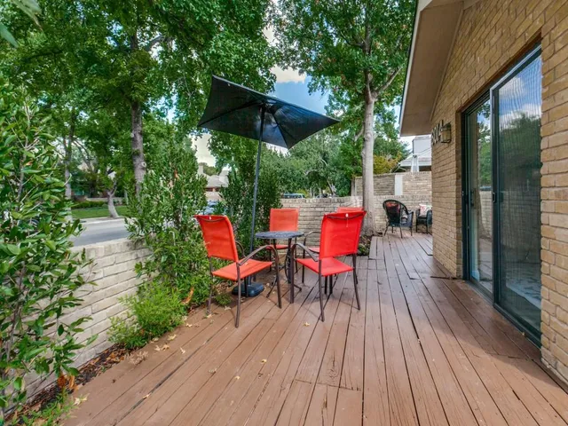 a view of deck with seating space and trees