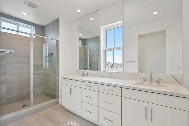a bathroom with double sink and a mirror