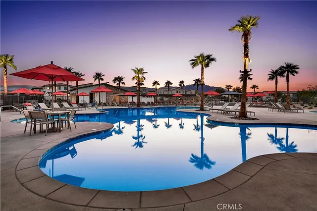 a roof deck with table and chairs under an umbrella