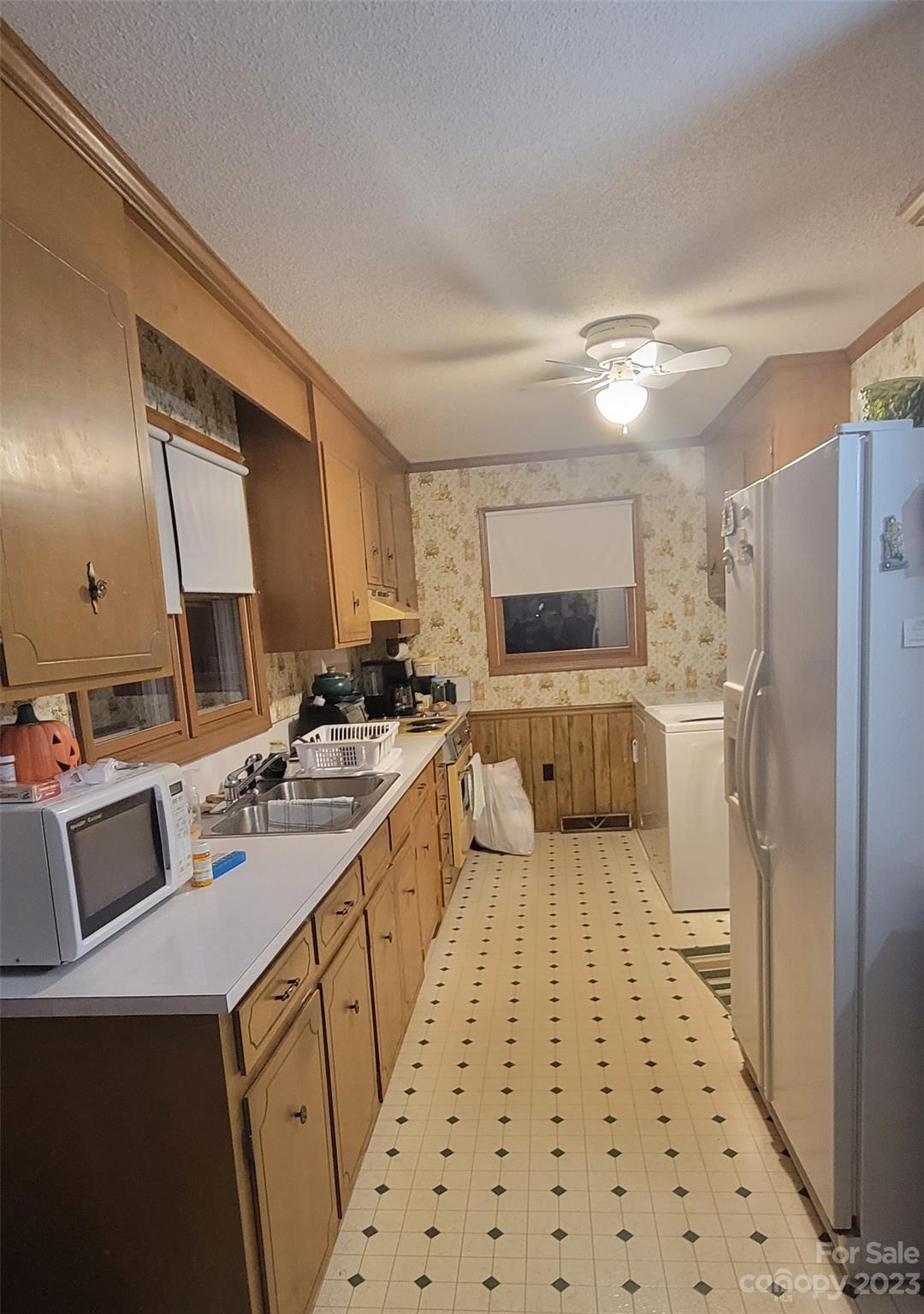 1366 Ridge Avenue Mount Pleasant, NC 28124 - Photo 12 of 28 a large white kitchen with a stove a sink and a refrigerator