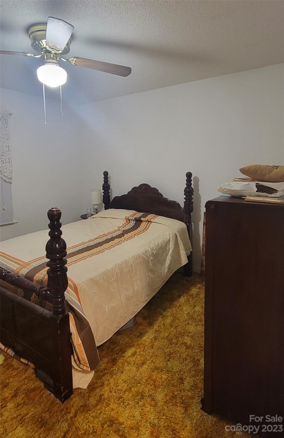 1366 Ridge Avenue Mount Pleasant, NC 28124 - Photo 21 of 28 a bed room with a bed and a chandelier