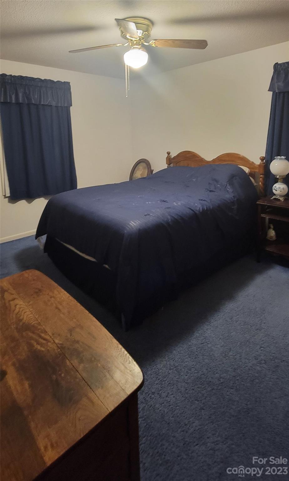 1366 Ridge Avenue Mount Pleasant, NC 28124 - Photo 25 of 28 a bedroom with a bed dresser and a chandelier
