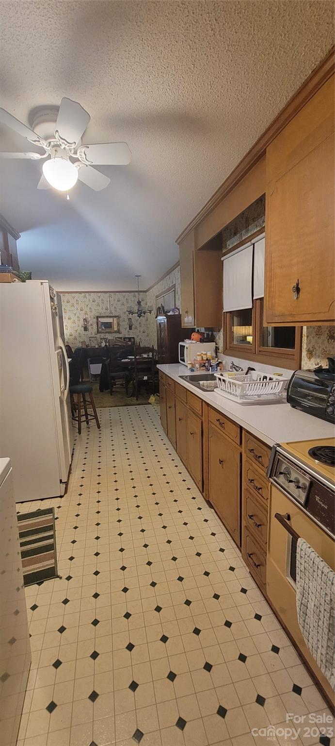 1366 Ridge Avenue Mount Pleasant, NC 28124 - Photo 26 of 28 a kitchen with a sink a stove cabinets and stainless steel appliances