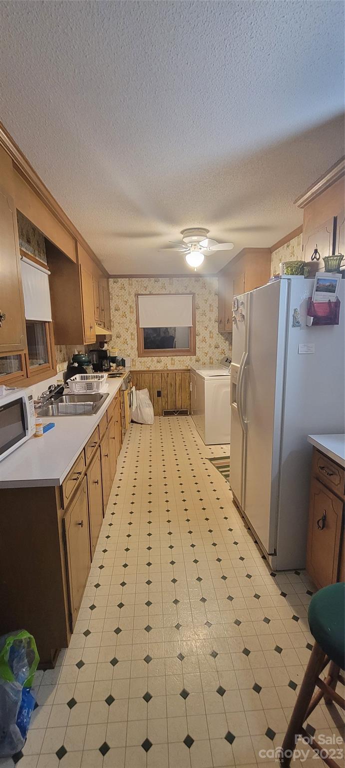 1366 Ridge Avenue Mount Pleasant, NC 28124 - Photo 27 of 28 a kitchen with a refrigerator a stove top oven a sink and dishwasher