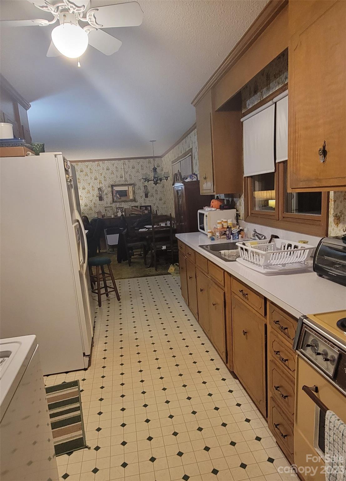 1366 Ridge Avenue Mount Pleasant, NC 28124 - Photo 9 of 28 a kitchen with a sink a stove cabinets and a dining table