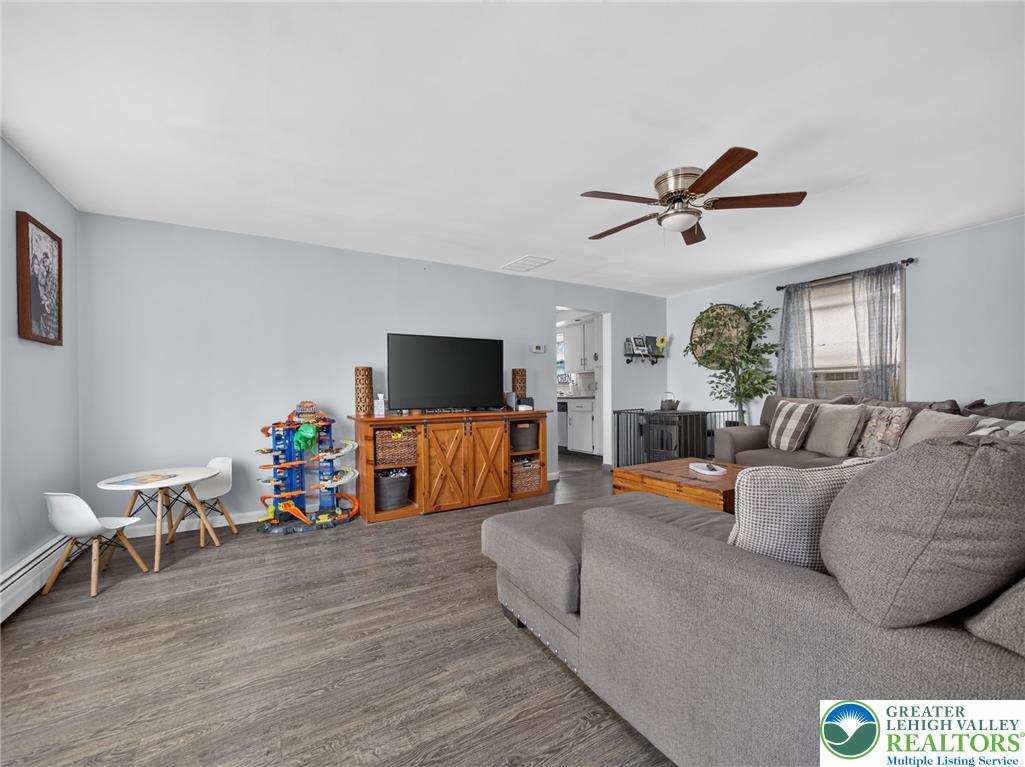 2628 Levans Road Coplay, PA 18037 - Photo 9 of 54 A comfortable living space featuring a ceiling fan and rich wood flooring.