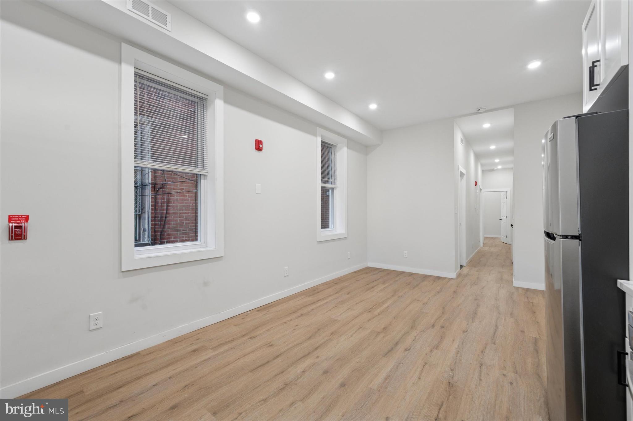 255 South 44th Street, Unit 1 Philadelphia, PA 19104 - Photo 13 of 26 a view of an empty room with wooden floor and a window