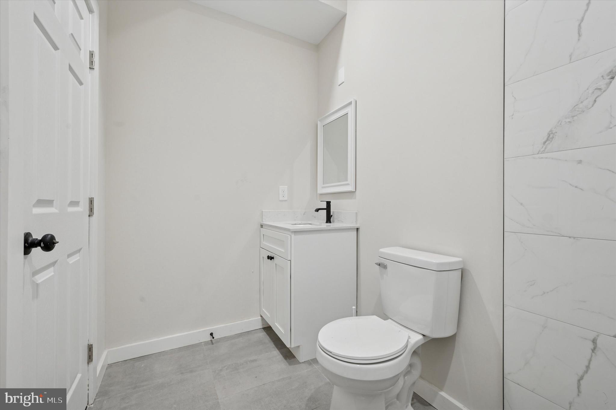 255 South 44th Street, Unit 1 Philadelphia, PA 19104 - Photo 24 of 26 a white toilet sitting next to a bathroom sink