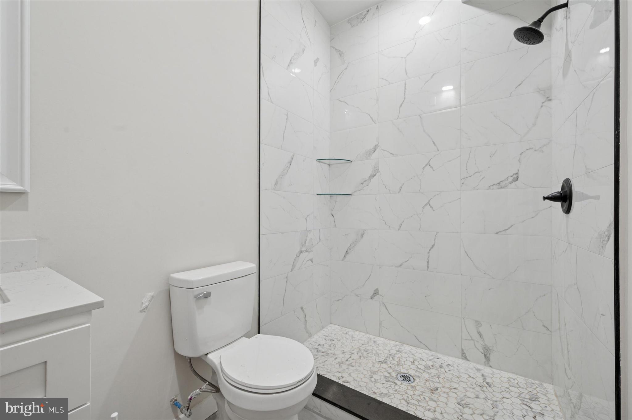 255 South 44th Street, Unit 1 Philadelphia, PA 19104 - Photo 25 of 26 a white toilet sitting next to a shower