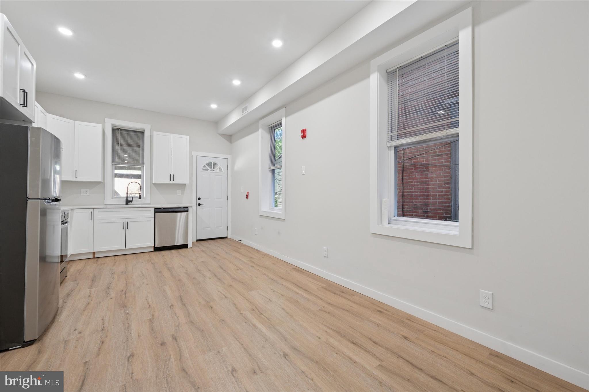 255 South 44th Street, Unit 1 Philadelphia, PA 19104 - Photo 7 of 26 a view of a kitchen with wooden floor and electronic appliances