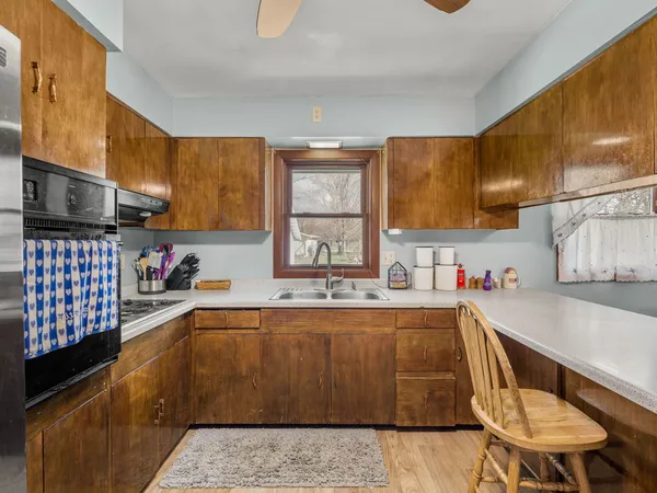 a kitchen with a sink appliances and cabinets