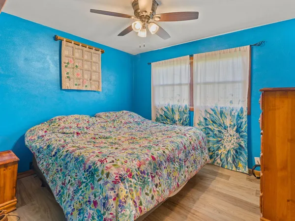 a bedroom with a bed and a chandelier