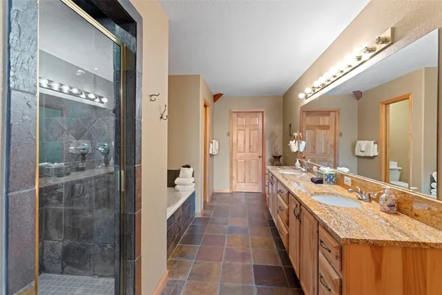 a large bathroom with a double vanity sink and a mirror