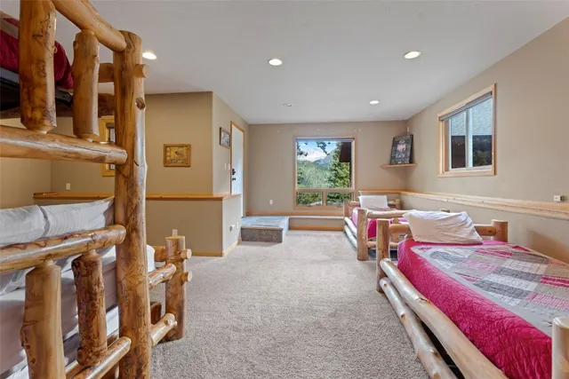 a living room with furniture a flat screen tv and a refrigerator
