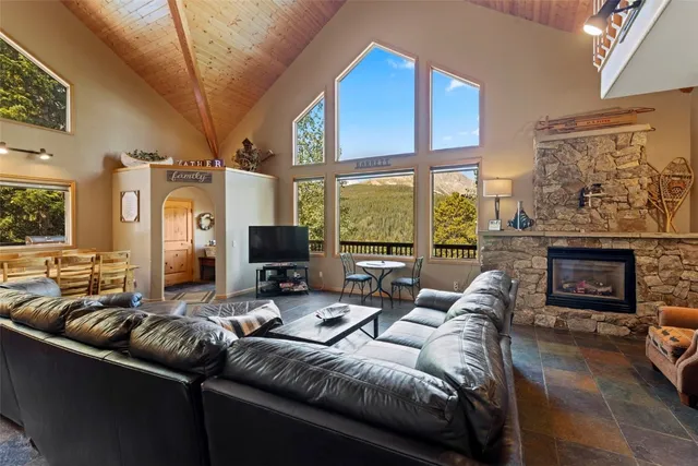 a living room with furniture a fireplace and a large window
