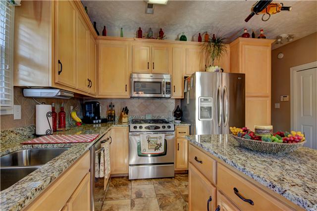 3580 Rabbit Run Trail Adams, TN 37010 - Photo 5 of 20 Ample cabinets to include built in pantry, work island, granite, gas stove, microwave, dishwasher, disposal. Tile floors and back-splash.