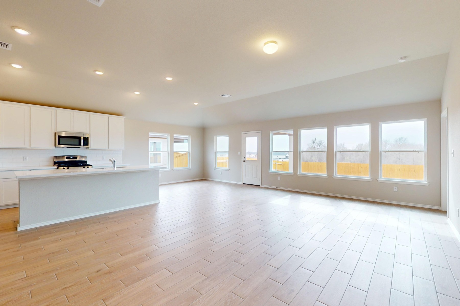 20009 Hirono Drive Manor, TX 78653 - Photo 2 of 39 a view of an empty room with kitchen and a window