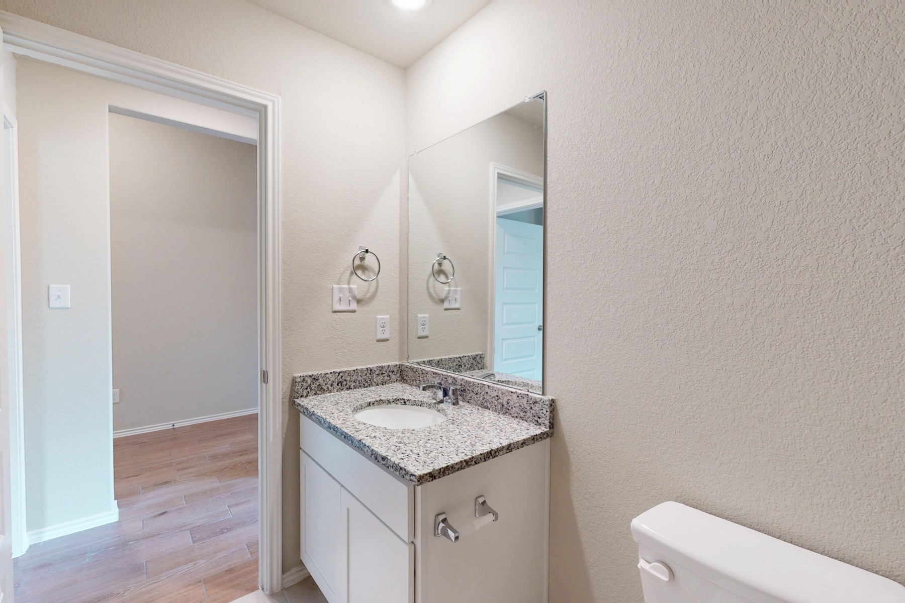 20009 Hirono Drive Manor, TX 78653 - Photo 26 of 39 a bathroom with a granite countertop sink and a mirror